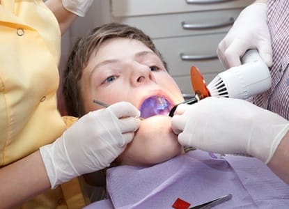 A young patient receiving a dental crown.