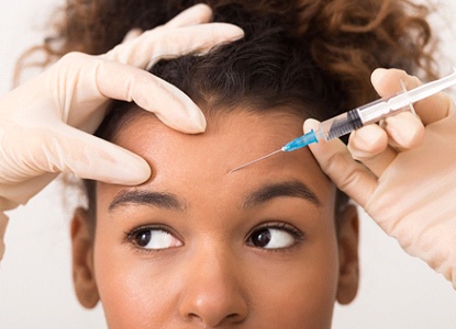 a patient receiving a BOTOX injection in their forehead