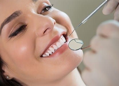 Woman receiving dental exam