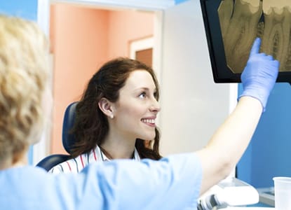 A dentist explaining an X-ray to a patient.