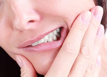 Closeup of patient holding jaw