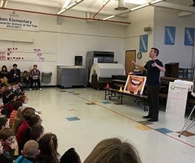 Dentist giving presentation to school children