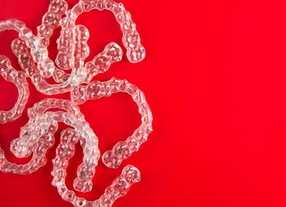 Invisalign aligners on red background