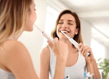 Woman brushing teeth