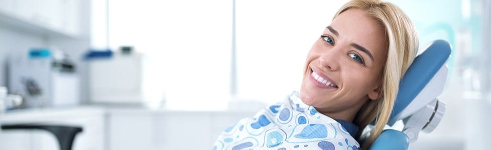 Woman in dental chair smiling