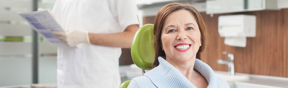 Smiling older woman in dental chair