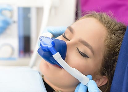 Woman with nitrous oxide nose mask