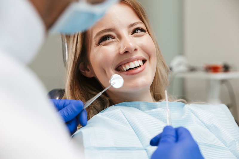 young woman sitting in dental chair during visit