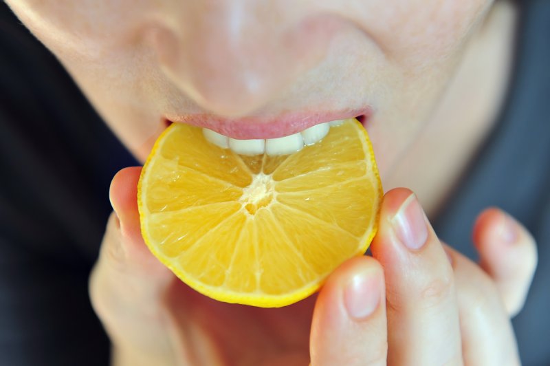 girl eating lemon